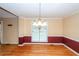 Charming dining room with hardwood floors, elegant lighting, and neutral wall colors at 1100 Cass Dr, Moncks Corner, SC 29461