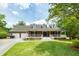 Charming brick home with a large front porch and well-manicured lawn creating inviting curb appeal at 1100 Cass Dr, Moncks Corner, SC 29461