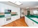Open kitchen featuring white cabinets, hardwood floors, stainless steel appliances, and ample counter space at 1100 Cass Dr, Moncks Corner, SC 29461
