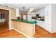 Bright kitchen with white cabinets, a breakfast bar, and views into other living spaces at 1100 Cass Dr, Moncks Corner, SC 29461