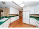 Well-lit kitchen with white cabinets, hardwood floors, a bright interior, and modern appliances at 1100 Cass Dr, Moncks Corner, SC 29461