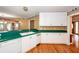 Bright kitchen featuring white cabinets, green countertops, hardwood floors, and modern appliances at 1100 Cass Dr, Moncks Corner, SC 29461