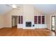Living room featuring high ceilings, a cozy fireplace, built-in shelving, and gleaming hardwood floors at 1100 Cass Dr, Moncks Corner, SC 29461