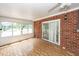Cozy sunroom with brick accent wall and large windows, perfect for relaxation and entertainment at 1100 Cass Dr, Moncks Corner, SC 29461