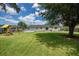 Large grassy backyard featuring an above-ground pool and a playset for outdoor fun at 115 Myers Rd, Summerville, SC 29486