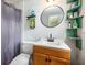 Compact bathroom featuring modern fixtures, a light wood vanity and a round mirror at 115 Myers Rd, Summerville, SC 29486
