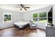 Bright bedroom featuring hardwood floors, a ceiling fan, and a window overlooking a green yard at 115 Myers Rd, Summerville, SC 29486