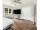 This bedroom has hardwood floors, a ceiling fan, a big closet and a view of the green yard at 115 Myers Rd, Summerville, SC 29486