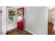 Bright entryway features a decorative red front door with glass panel and wood-look flooring at 115 Myers Rd, Summerville, SC 29486