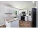 Modern kitchen features white cabinets, granite countertops, and stainless steel appliances at 115 Myers Rd, Summerville, SC 29486