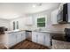 Bright kitchen with white cabinets, stainless steel appliances, granite countertops, and a subway tile backsplash at 115 Myers Rd, Summerville, SC 29486