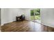 A bright office space with wood floors, shiplap accent wall, and sliding glass door to the backyard at 115 Myers Rd, Summerville, SC 29486