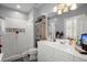 Bright bathroom with white vanity, shower, a cabinet, and modern fixtures at 115 S Ainsdale Dr, Charleston, SC 29414