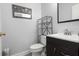 Bathroom featuring a dark vanity, toilet, mirror and metal shelving at 115 S Ainsdale Dr, Charleston, SC 29414