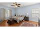 Well-lit bedroom with hardwood floors, patterned bedding, and stylish accents at 115 S Ainsdale Dr, Charleston, SC 29414
