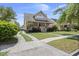Attractive home with a spacious lawn, a front porch, and a curving driveway leading to a detached garage at 115 S Ainsdale Dr, Charleston, SC 29414