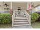 Charming front porch with decorative accents, a welcoming American flag, and stairs leading to the entrance at 115 S Ainsdale Dr, Charleston, SC 29414