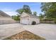 A detached garage with a white door sits in a concrete driveway, perfect for extra storage and parking at 115 S Ainsdale Dr, Charleston, SC 29414