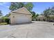 Detached single car garage with neutral siding and a concrete driveway is perfect for parking or storage at 115 S Ainsdale Dr, Charleston, SC 29414
