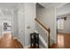 Hallway with wood floors, white trim, and a staircase leading to the upper level of the home at 115 S Ainsdale Dr, Charleston, SC 29414