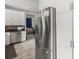 Modern kitchen features stainless steel appliances, white cabinetry, and flows into living area at 115 S Ainsdale Dr, Charleston, SC 29414