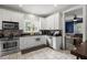 Well-lit kitchen features granite countertops, tile backsplash, stainless steel appliances, and white cabinetry at 115 S Ainsdale Dr, Charleston, SC 29414