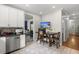 Bright kitchen with stainless steel dishwasher and wooden table with two chairs at 115 S Ainsdale Dr, Charleston, SC 29414
