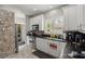 Bright kitchen with stainless steel appliances, white cabinets, and a view to the laundry room at 115 S Ainsdale Dr, Charleston, SC 29414