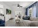 Cozy living room featuring comfortable seating, a ceiling fan, and access to a sunlit area at 115 S Ainsdale Dr, Charleston, SC 29414