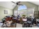A lovely in-home office space with large windows, a ceiling fan, and multiple workstations at 115 S Ainsdale Dr, Charleston, SC 29414
