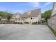 Beige two story home featuring a concrete driveway with stairs leading to dual entrance doors at 115 S Ainsdale Dr, Charleston, SC 29414