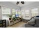 Bright sunroom with lots of windows, neutral paint, and tile flooring at 115 S Ainsdale Dr, Charleston, SC 29414