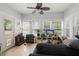Inviting sunroom with large windows and door, neutral paint, and tile flooring at 115 S Ainsdale Dr, Charleston, SC 29414