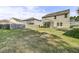 A large, flat backyard with a view of other houses and a screened in porch at 118 Beacon Falls Ct, Summerville, SC 29486