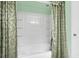 Bright, airy bathroom features a white tub/shower combo with decorative shower curtains at 118 Beacon Falls Ct, Summerville, SC 29486