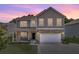 Charming two-story home featuring stone accents, a covered porch, and a two-car garage at 118 Beacon Falls Ct, Summerville, SC 29486