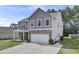 Well-kept two-story home boasting a stone facade, covered porch, and spacious driveway at 118 Beacon Falls Ct, Summerville, SC 29486