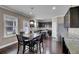Eat-in kitchen features dark cabinetry, granite countertops, stainless appliances and hardwood floors at 118 Beacon Falls Ct, Summerville, SC 29486