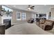 Inviting living room with a fireplace, comfortable seating, and an open view to the kitchen at 118 Beacon Falls Ct, Summerville, SC 29486