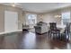 Spacious living and dining area with hardwood floors, elegant furnishings, and ample natural light at 118 Beacon Falls Ct, Summerville, SC 29486