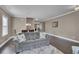 Open-concept living area with hardwood floors, a comfortable sofa, and a view into the dining space at 118 Beacon Falls Ct, Summerville, SC 29486