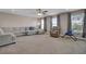 Expansive living room features neutral carpet, sofa and large windows offering natural light at 118 Beacon Falls Ct, Summerville, SC 29486
