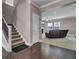 Inviting living room with a cozy brown sofa and a view of the staircase and entry at 118 Beacon Falls Ct, Summerville, SC 29486