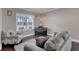 Cozy living room featuring hardwood floors, comfortable seating, and natural light from a large window at 118 Beacon Falls Ct, Summerville, SC 29486