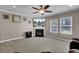 Cozy living room features a fireplace with mounted television and two windows for natural light at 118 Beacon Falls Ct, Summerville, SC 29486