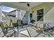A screened porch with a ceiling fan, chairs, a table, a grill and view of the backyard at 118 Beacon Falls Ct, Summerville, SC 29486