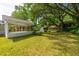 Expansive backyard featuring a screened porch, storage shed, and lush greenery at 1226 Forestwood Dr, Charleston, SC 29407