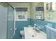 Bathroom featuring a vanity, blue tile accents, wallpaper, and a shower with glass doors at 1226 Forestwood Dr, Charleston, SC 29407