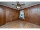 Bedroom featuring hardwood floors, wood paneling, a ceiling fan, and a single window at 1226 Forestwood Dr, Charleston, SC 29407