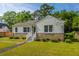 Charming home features stone accents, a green lawn, and an inviting front porch at 1226 Forestwood Dr, Charleston, SC 29407
